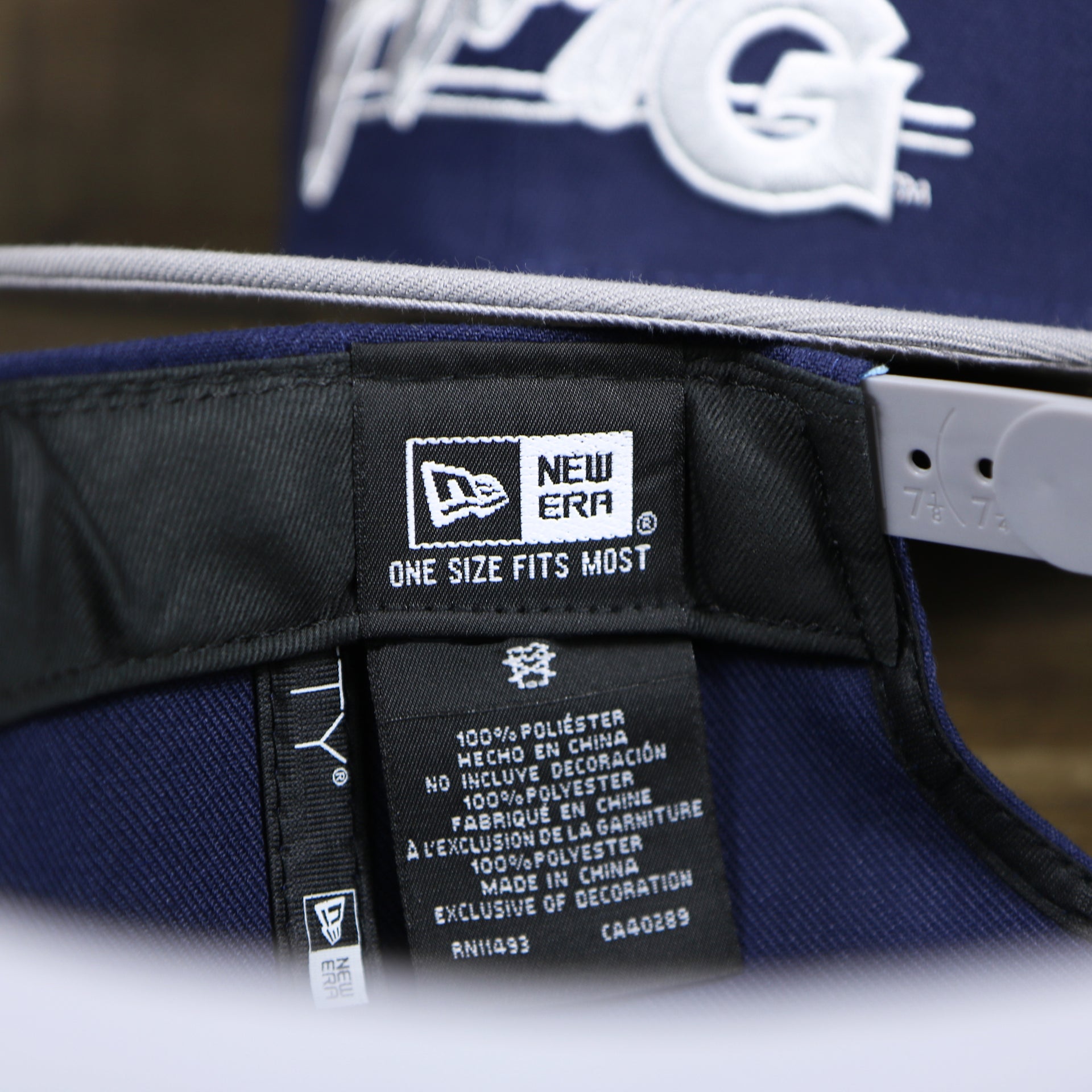 The New Era Tag on the Georgetown Hoyas Team Script Gray Bottom 9Fifty Snapback | Navy Blue And Gray Snap Cap