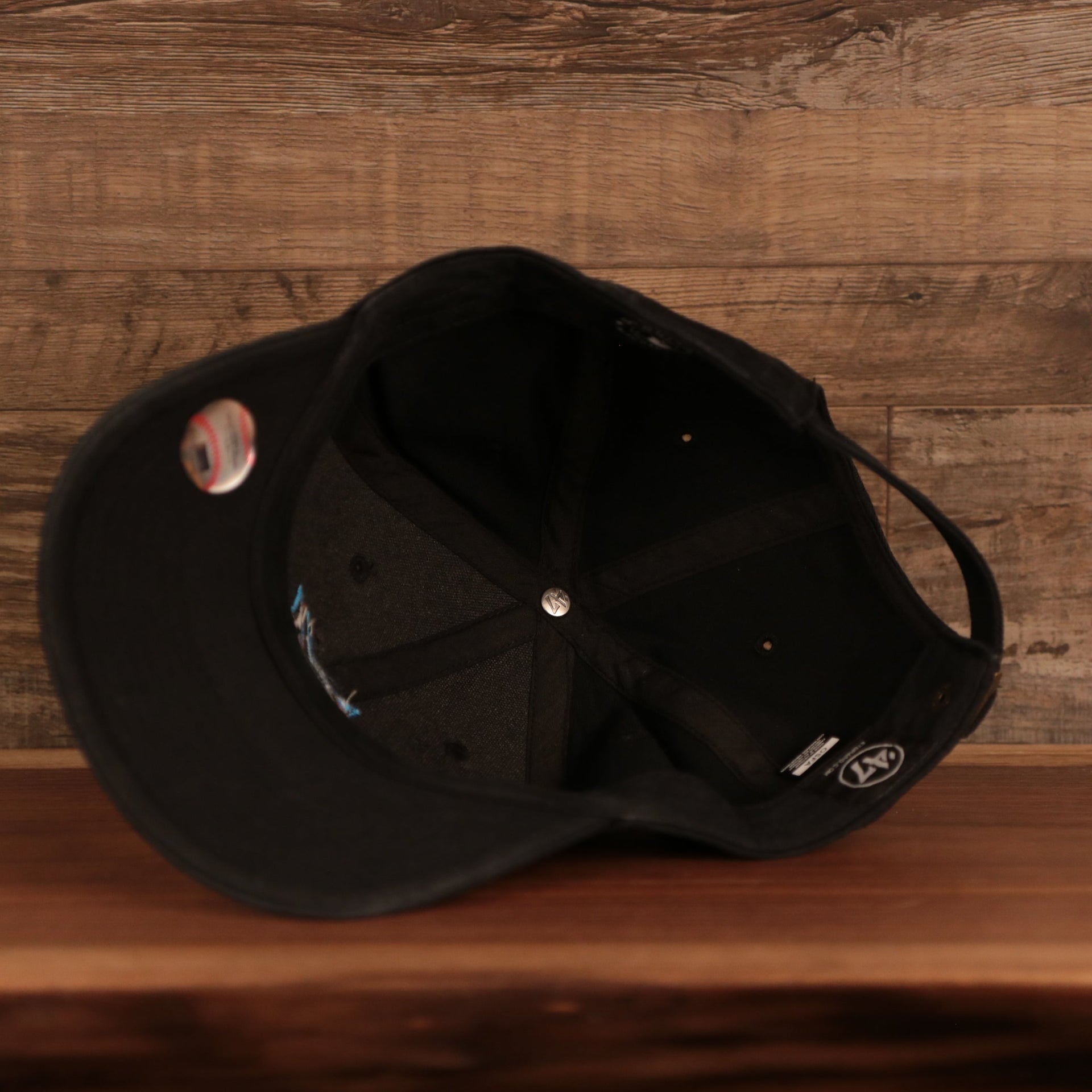 underside of the Miami Marlins Black Adjustable Dad Hat