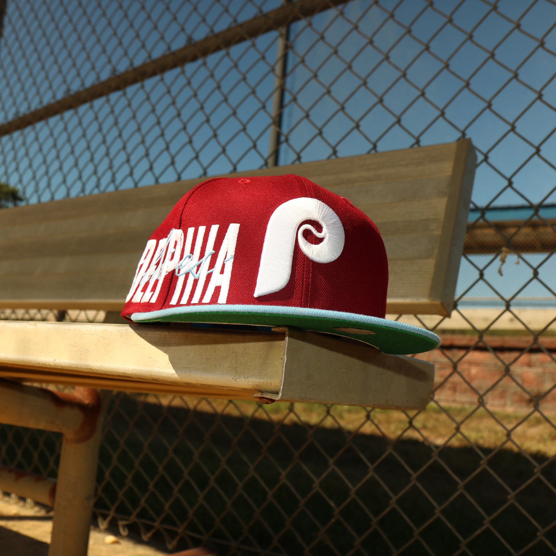 The Cooperstown Philadelphia Phillies MLB Side Font Green Bottom 9Fifty Snapback Cap | Maroon Snap Cap at a lower angle