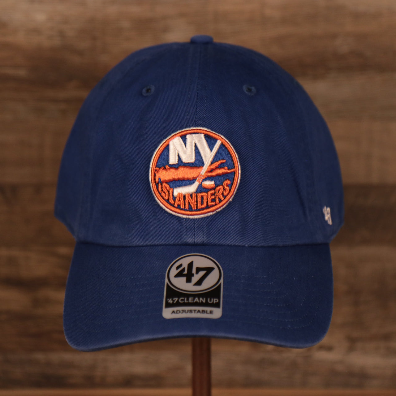 front of the New York Islanders Royal Blue Adjustable Dad Hat
