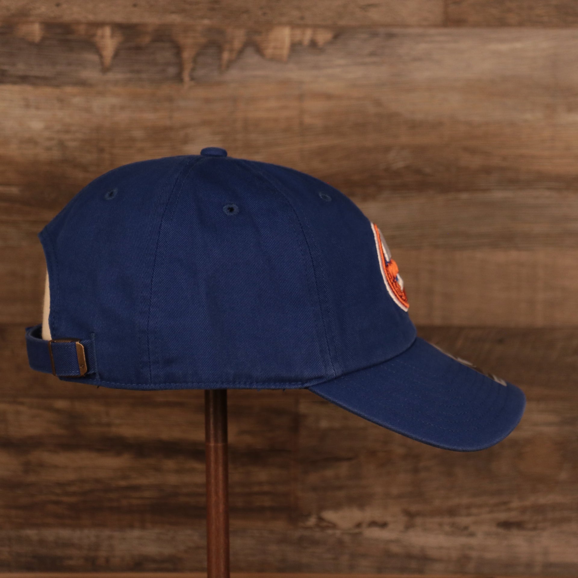 wearers right side of the New York Islanders Royal Blue Adjustable Dad Hat
