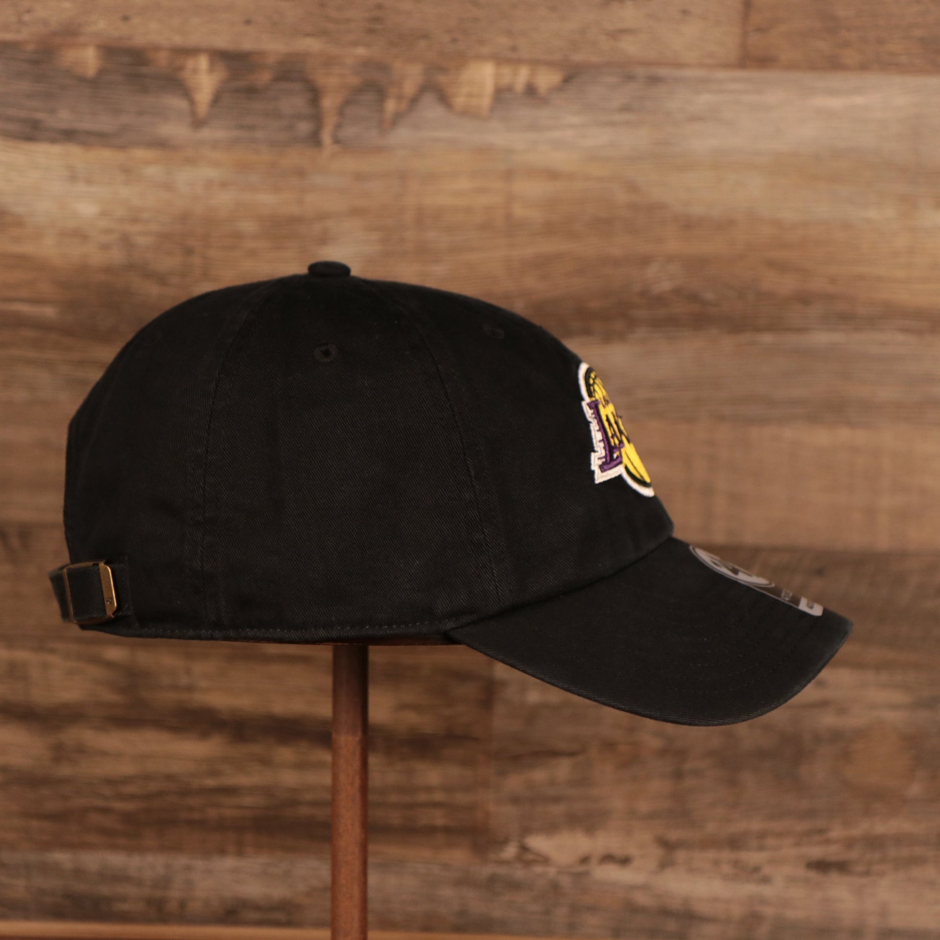 wearers right side of the Los Angeles Lakers Black Adjustable Dad Hat