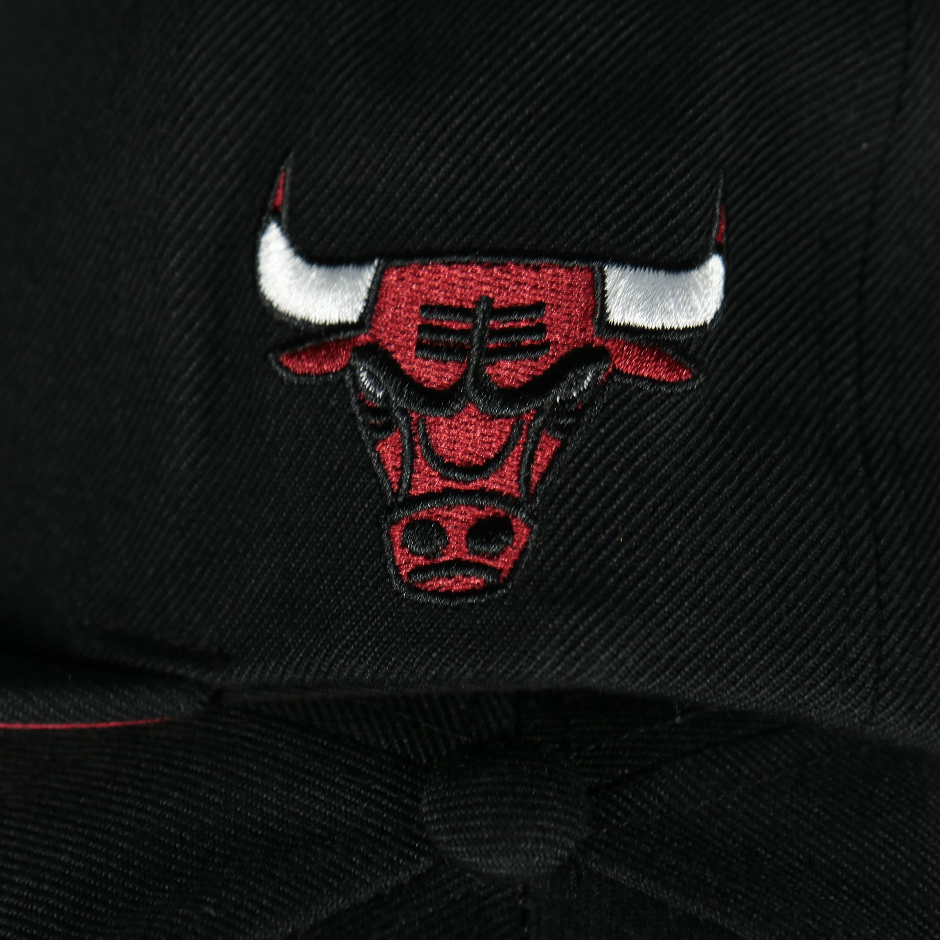 bulls logo on the Chicago Bulls Vintage Retro NBA Team Script 2.0 Mitchell and Ness Snapback Hat | Black