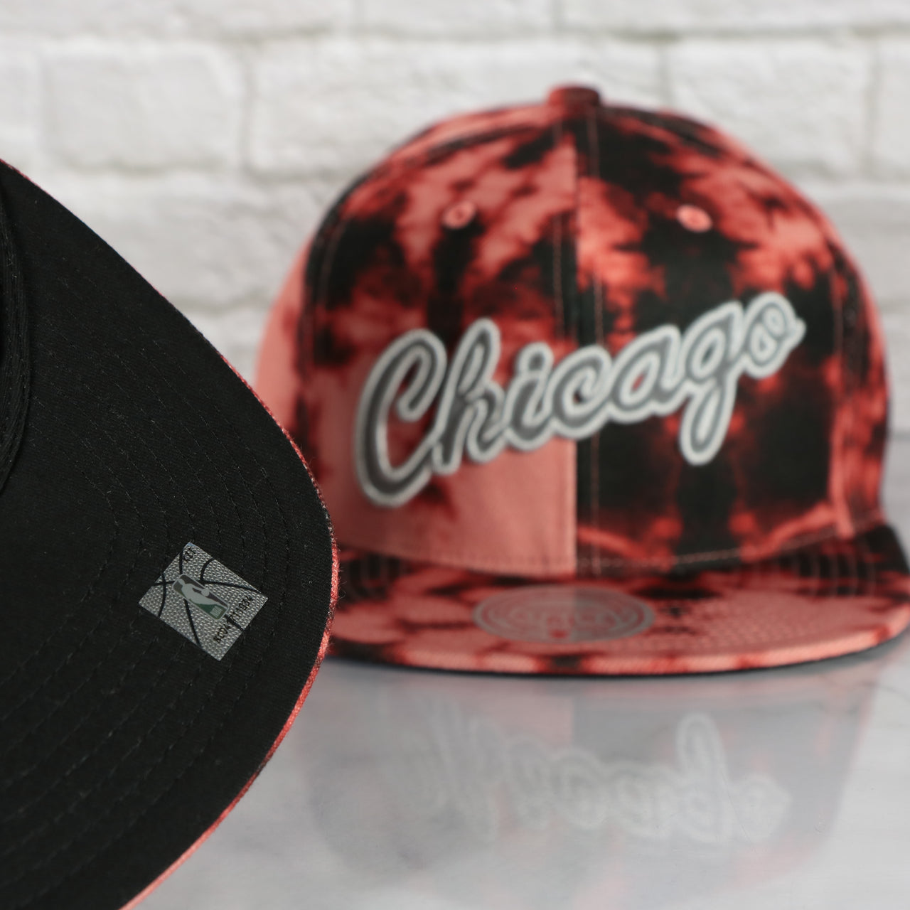 black under visor on the Chicago Bulls Galaxy Red Reflective Script Mitchell and Ness Snapback Hat