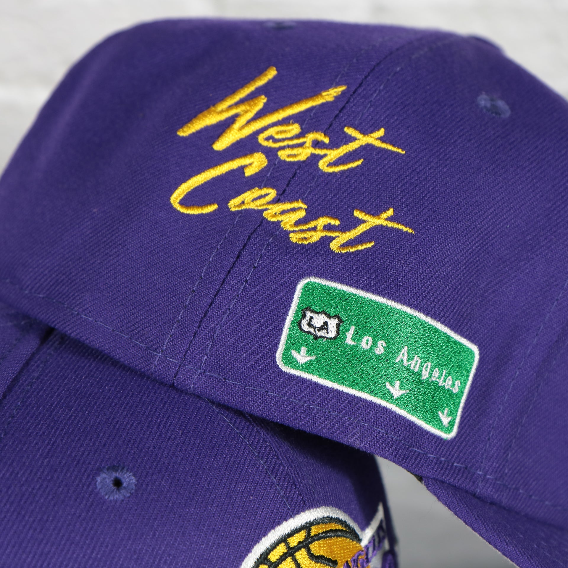 west coast script on the Los Angeles Lakers City Transit All Over Side Patch Gray Bottom 59Fifty Fitted Cap