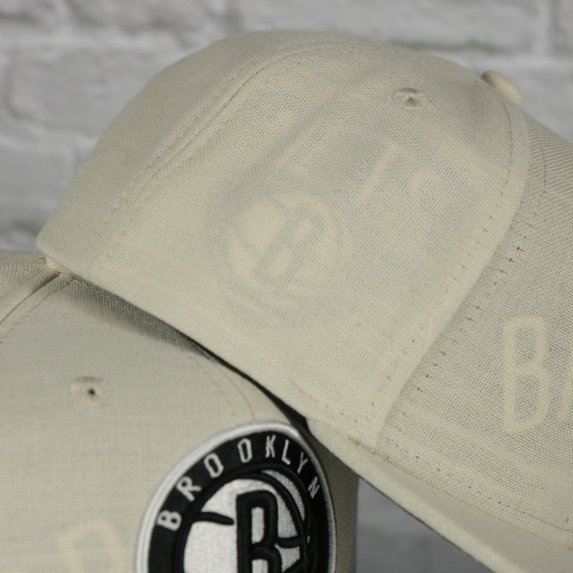 wearer's right of the Brooklyn Nets Cut Away Snapback Hat | Retro Mitchell and Ness Rip Away Distressed Snapback Hat