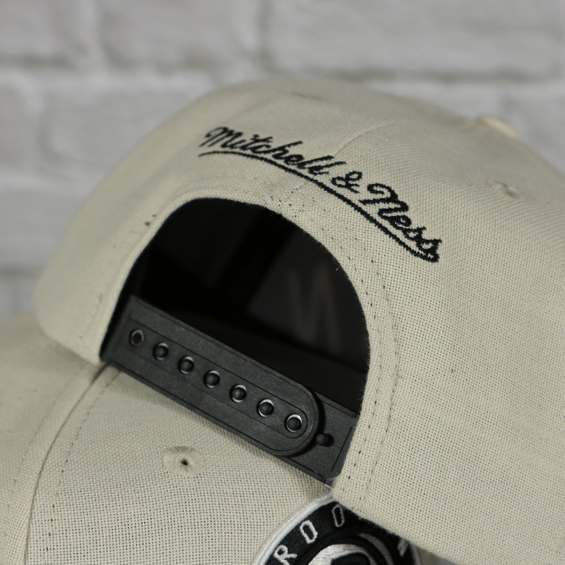 mitchell and ness logo on the Brooklyn Nets Cut Away Snapback Hat | Retro Mitchell and Ness Rip Away Distressed Snapback Hat