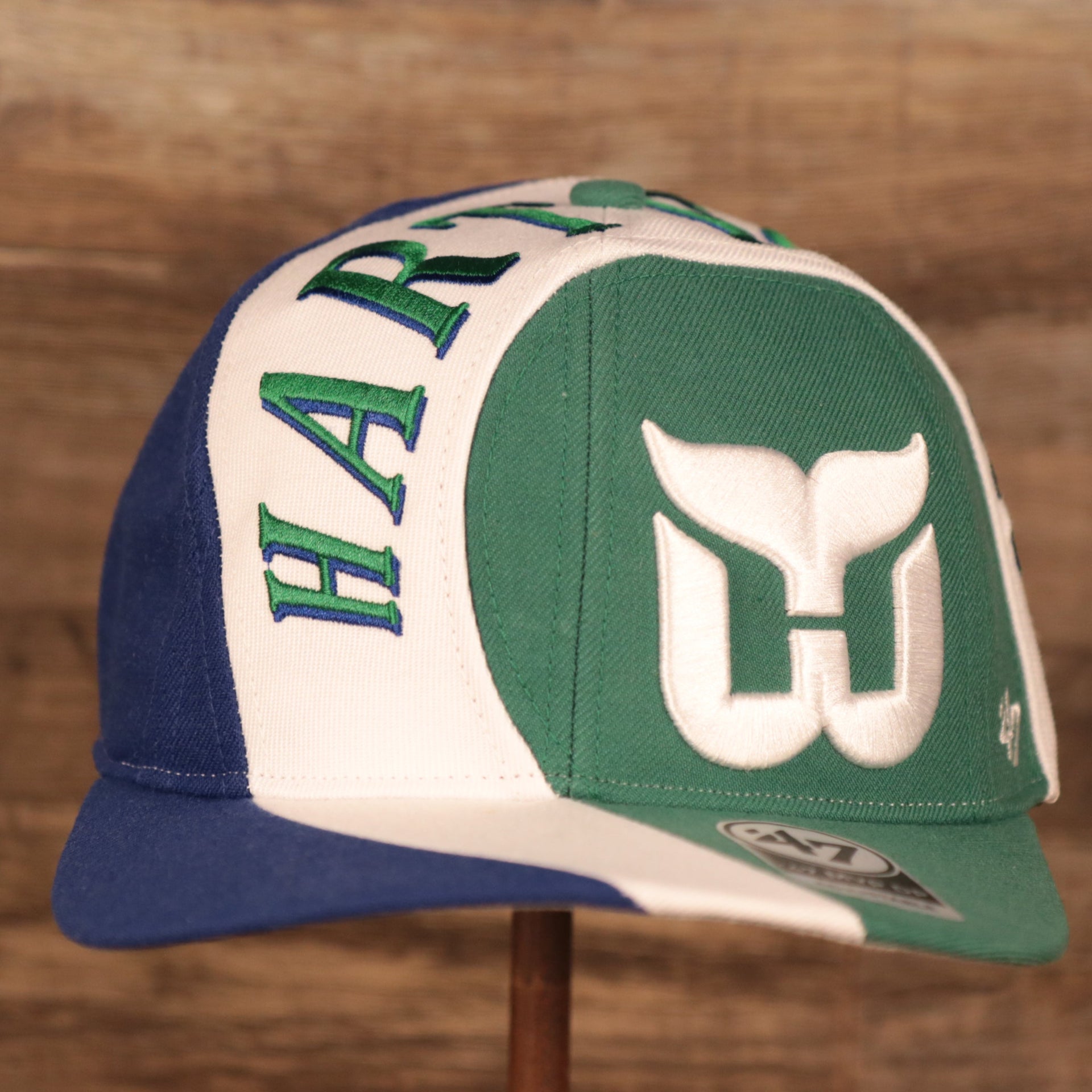 front of the Hartford Whalers Blue White & Green Retro Adjustable Snapback Cap
