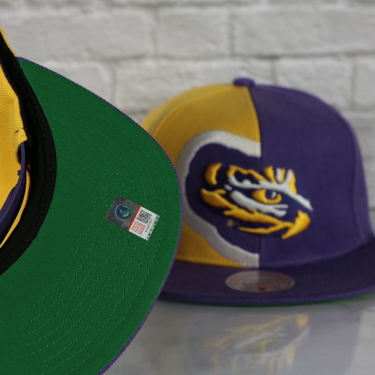 green under visor on the Louisiana State University Tigers Retroline Logo Outline Vintage Snapback Hat | Mitchell and Ness Tigers Snap Cap