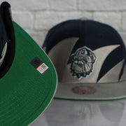 green under visor on the Georgetown University Hoyas Vintage Retro Sharktooth Mitchell and Ness Snapback Hat | Gray/Navy Blue
