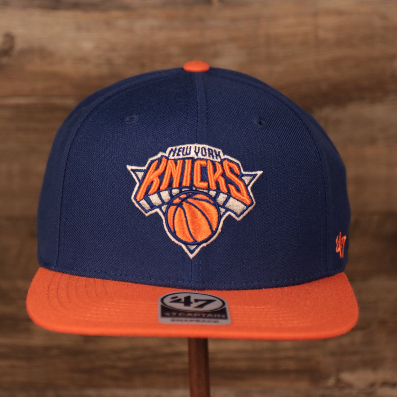 front of the New York Knicks Royal Blue and Orange Adjustable Grey Bottom Snapback Hat