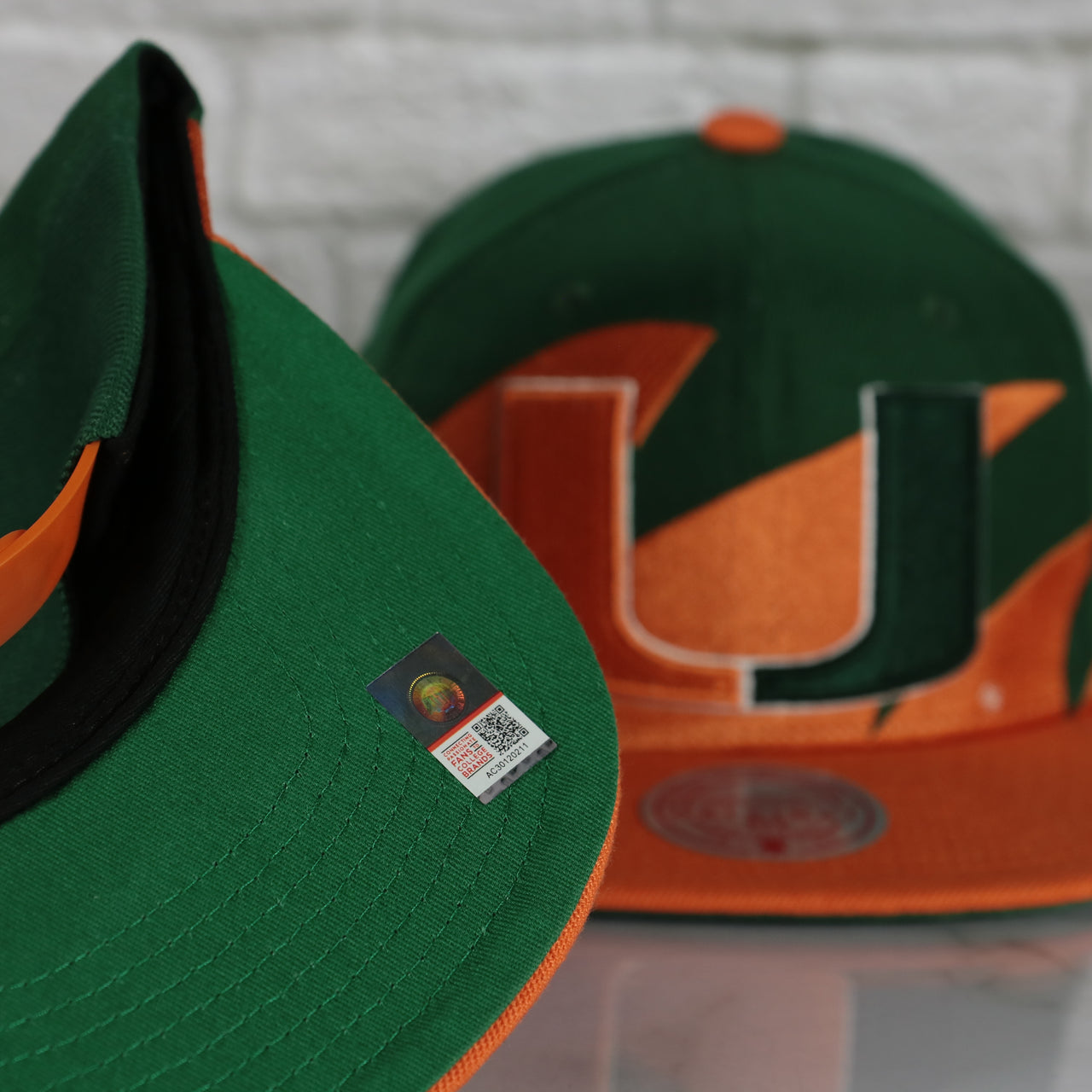 green under visor on the University of Miami Hurricanes Vintage Retro Sharktooth Mitchell and Ness Snapback Hat | Orange/Green