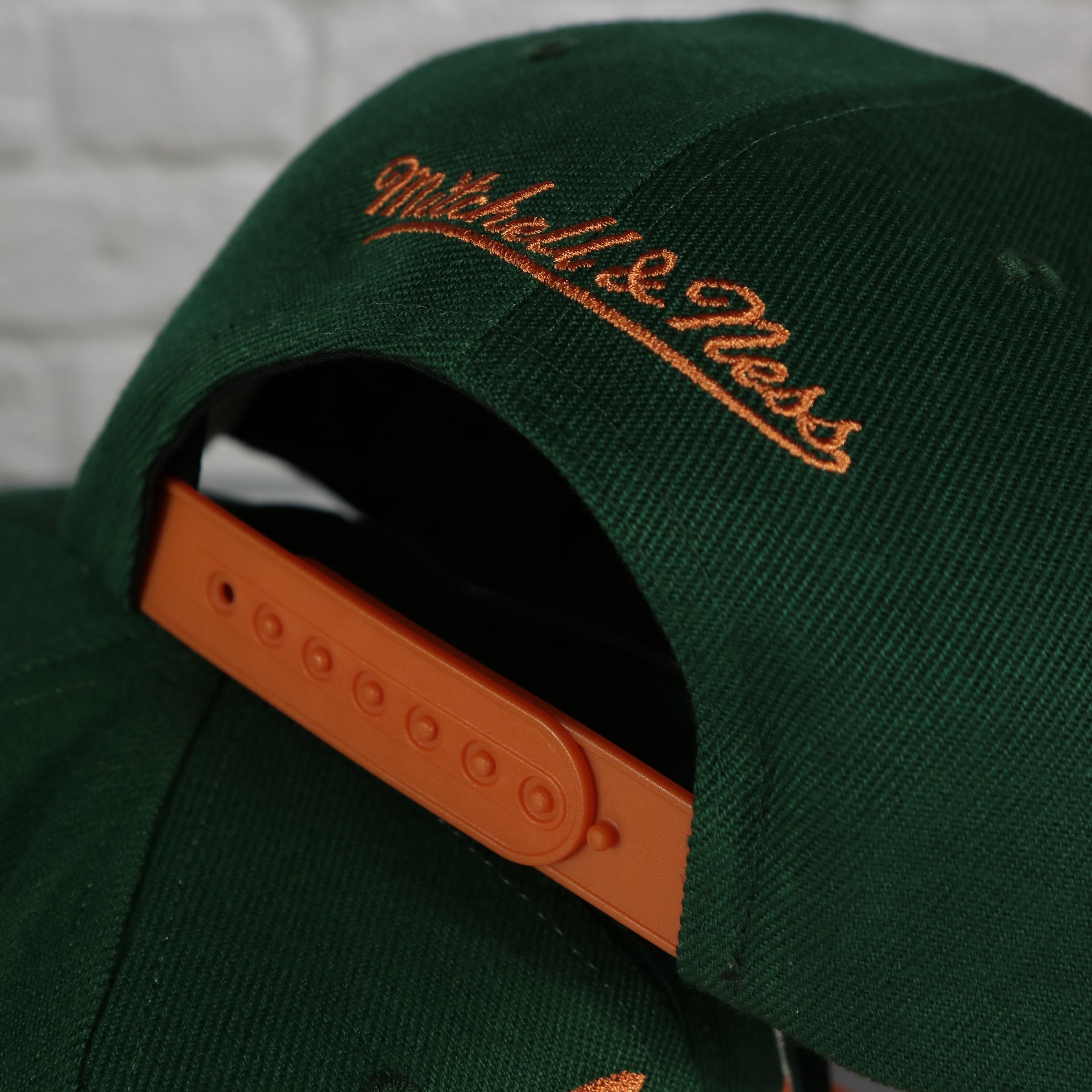 mitchell and ness logo on the University of Miami Hurricanes Vintage Retro Sharktooth Mitchell and Ness Snapback Hat | Orange/Green