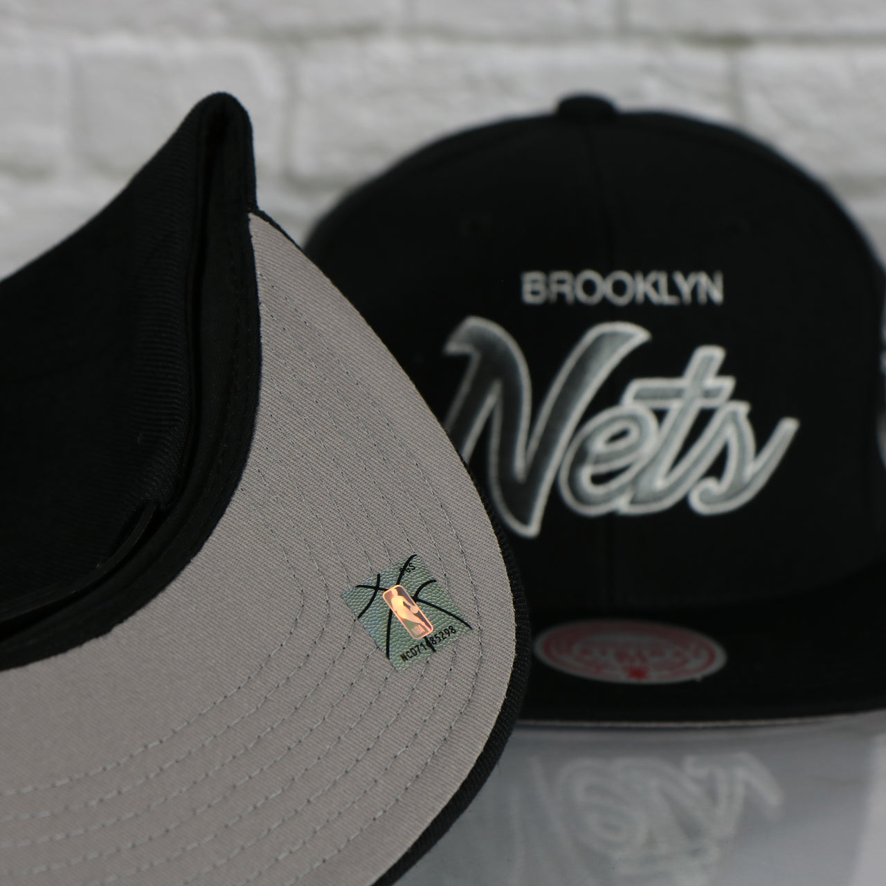 grey under visor on the Brooklyn Nets Vintage Retro NBA Team Script 2.0 Mitchell and Ness Snapback Hat | Black