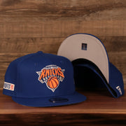 The New York Knicks 2021 NBA Playoffs snapback hat features a structured crown, flat brim, and gray under brim