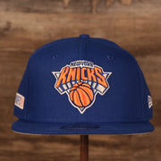 Embroidered on the front of the 2021 NBA Playoffs New York Knicks Snapback Hat is the New York Knicks logo in white, blue, and orange