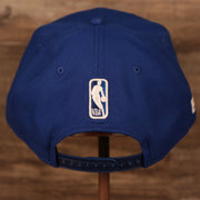 Embroidered on the back of the New York Knicks 2021 NBA Playoffs snapback hat is the NBA logo in royal blue and white