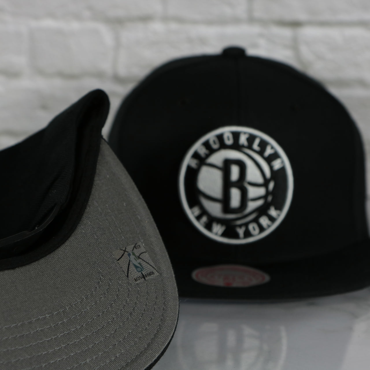 grey under visor on the Brooklyn Nets Vintage Retro NBA Team Ground 2.0 Mitchell and Ness Snapback Hat | Black