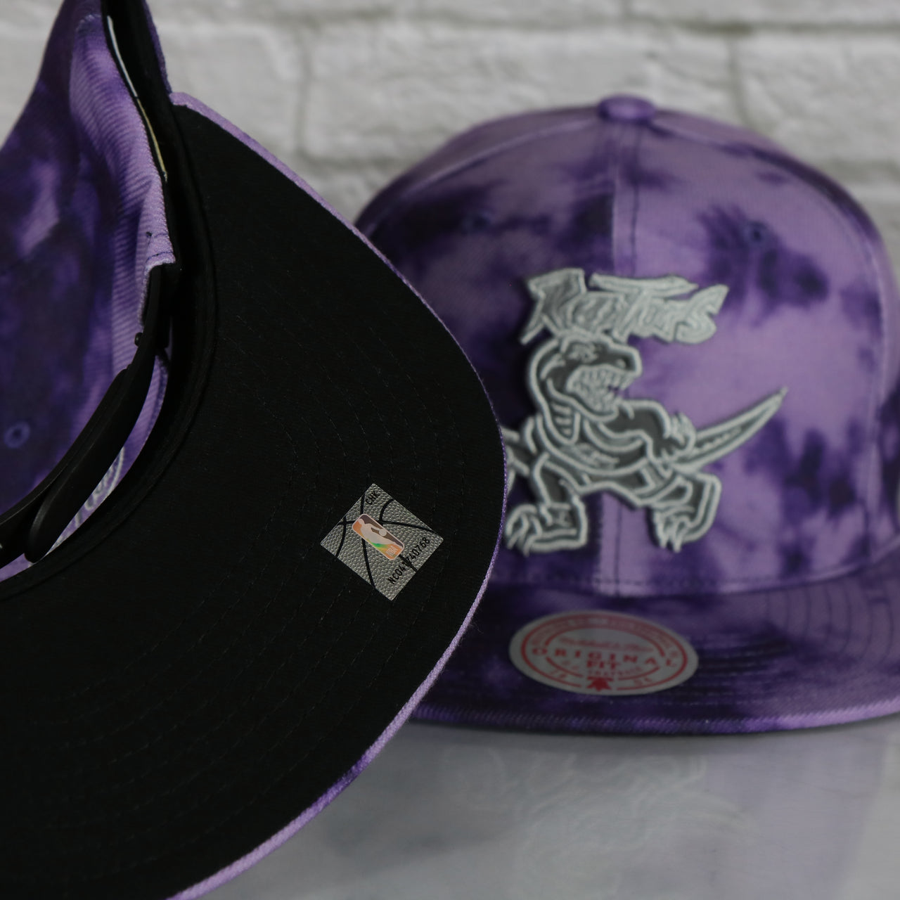 black under visor on the Toronto Raptors Galaxy Purple Reflective Script Mitchell and Ness Snapback Hat