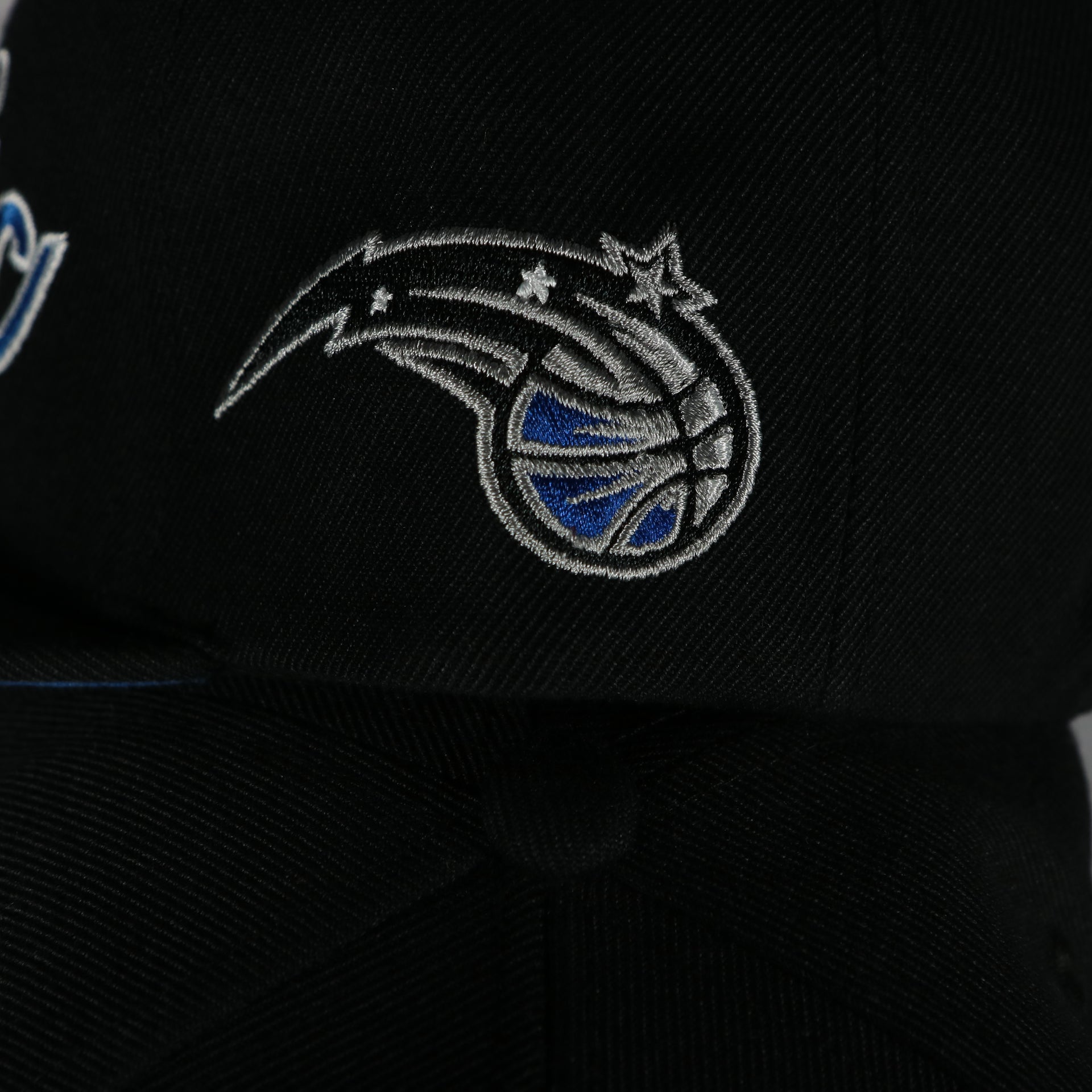 magic logo on the Orlando Magic Vintage Retro NBA Team Script 2.0 Mitchell and Ness Snapback Hat | Black