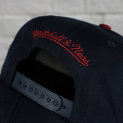 mitchell and ness logo on the New Jersey Nets Vintage Retro NBA Team 2 Tone Mitchell and Ness Snapback Hat | Navy/Red