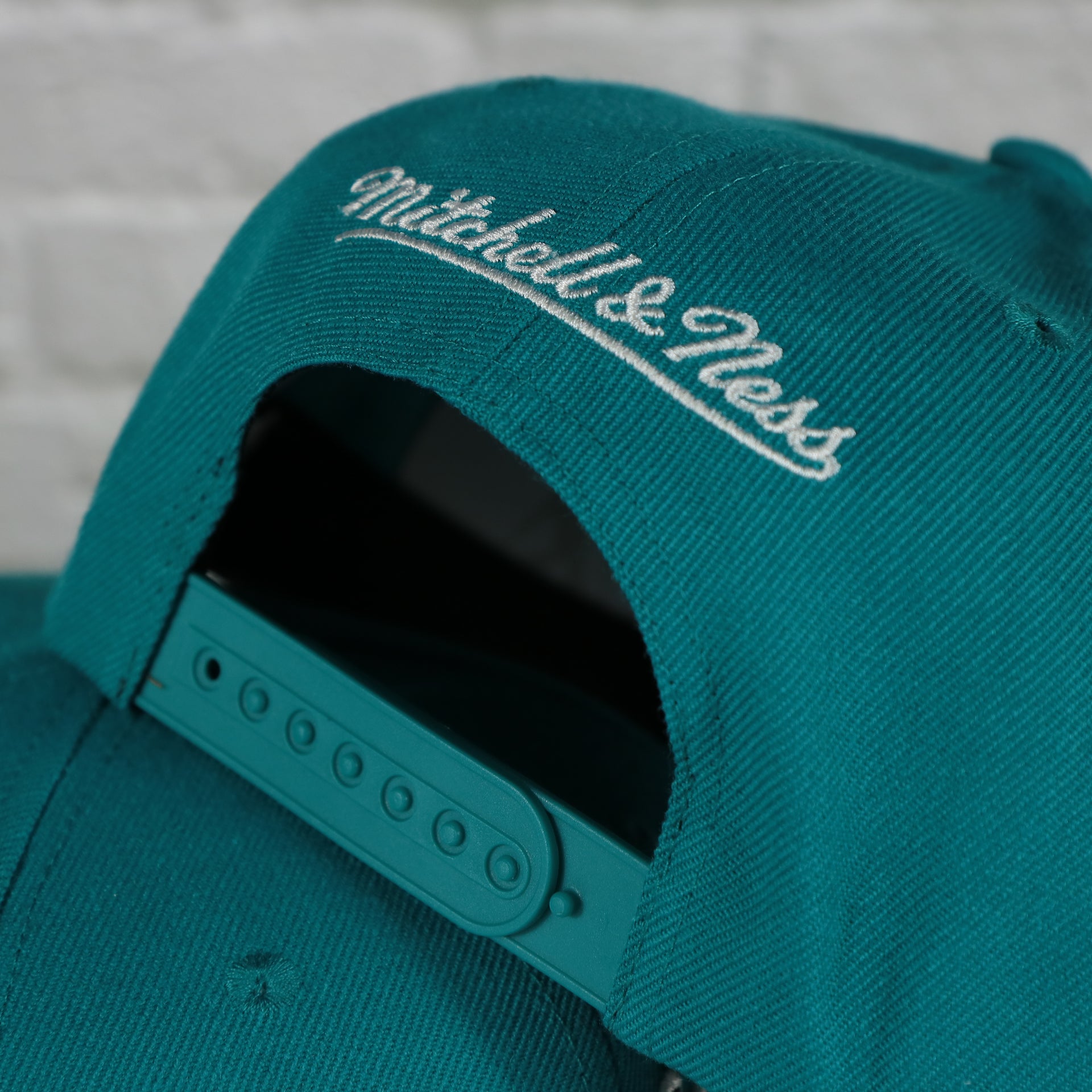 mitchell and ness logo on the Charlotte Hornets Vintage Retro NBA Team Ground 2.0 Mitchell and Ness Snapback Hat | Teal