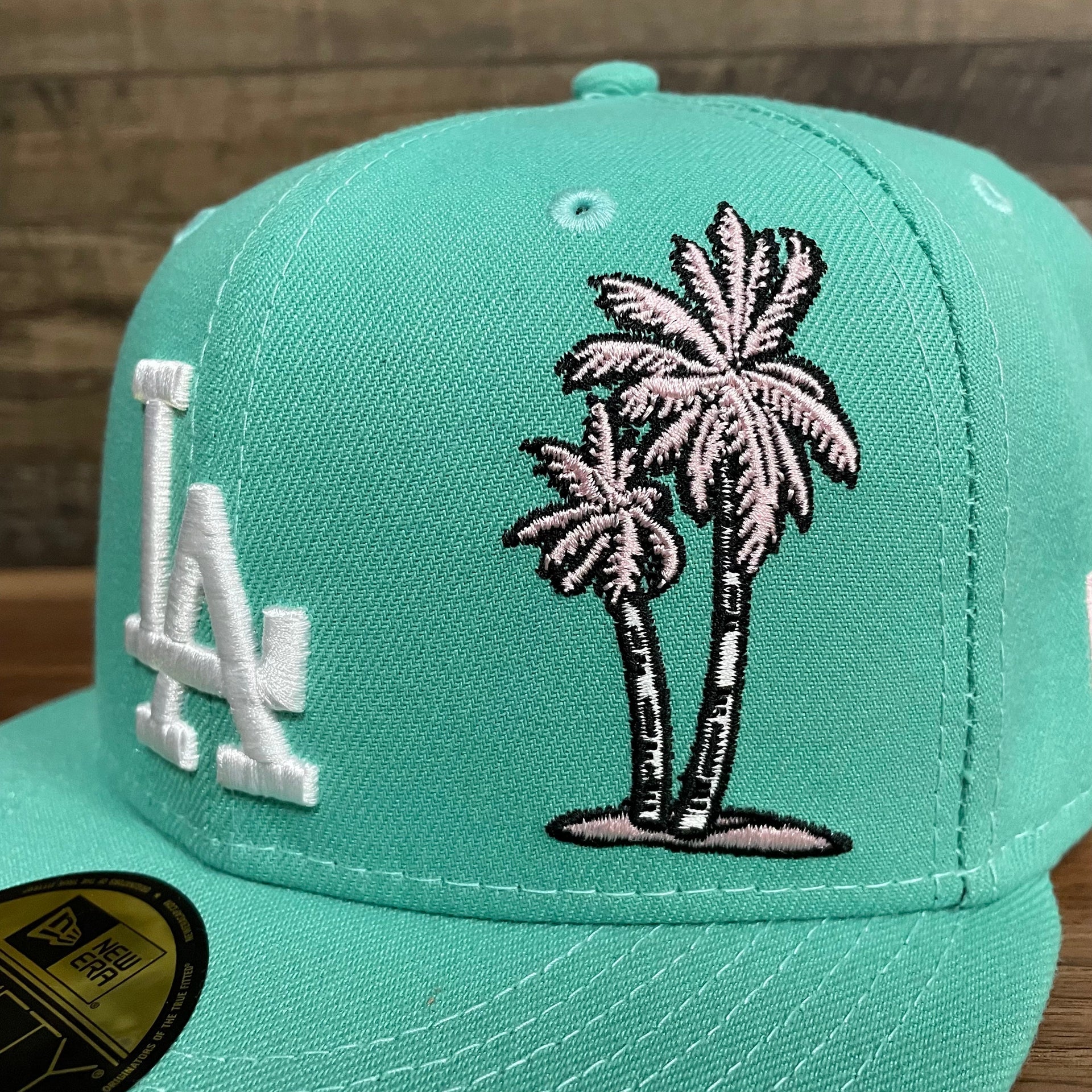 Close up of the pink palm tree embroidery on the 50th Anniversary Los Angeles Dodgers Palm Tree Pink Bottom Side Patch 5950 Fitted | "Mint Flamingo"