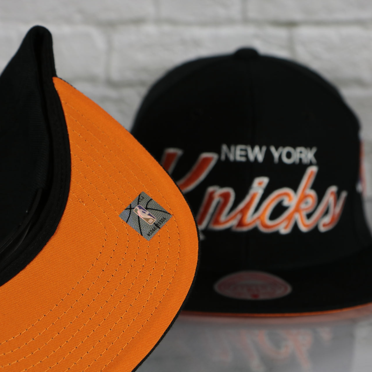 orange under visor on the New York Knicks Vintage Retro NBA Team Script 2.0 Mitchell and Ness Snapback Hat | Black