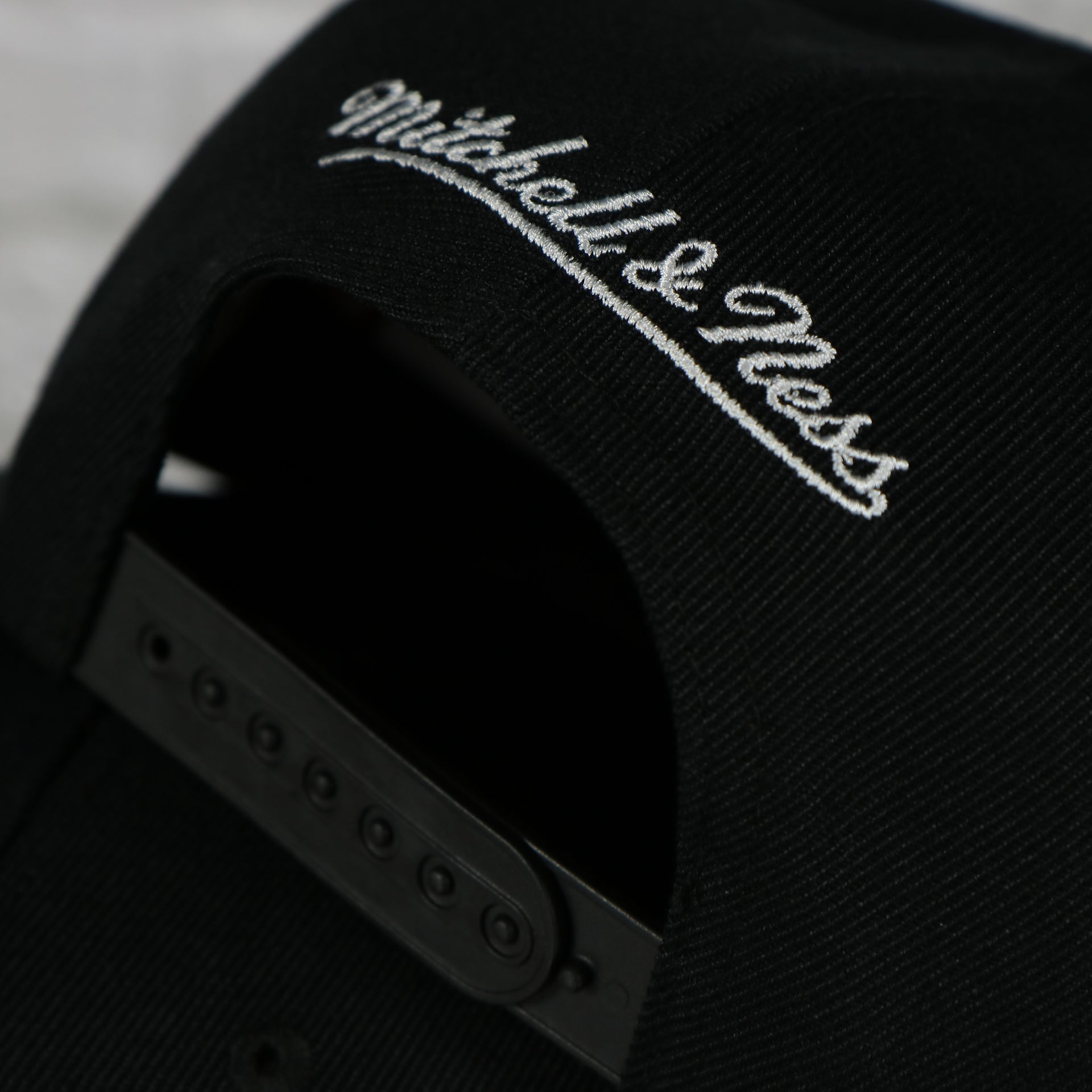 mitchell and ness logo on the New York Knicks Vintage Retro NBA Team Script 2.0 Mitchell and Ness Snapback Hat | Black