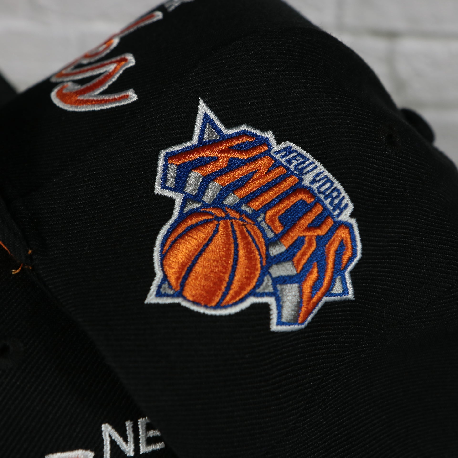 knicks logo on the New York Knicks Vintage Retro NBA Team Script 2.0 Mitchell and Ness Snapback Hat | Black