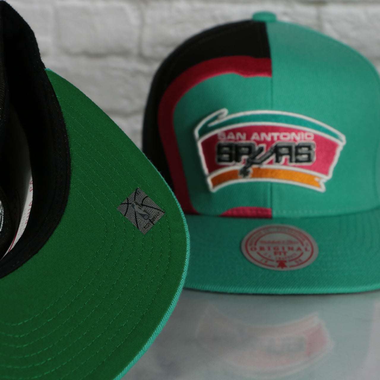 green under visor on the San Antonio Spurs Retroline Logo Outline Vintage Snapback Hat | Mitchell and Ness Spurs Snap Cap