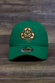 the Boston Celtics 2019 City Series Dad Hat | Irish Green Adjustable Boston Celtics Baseball Cap with Golden Shamrock has a large gold shamrock on the front