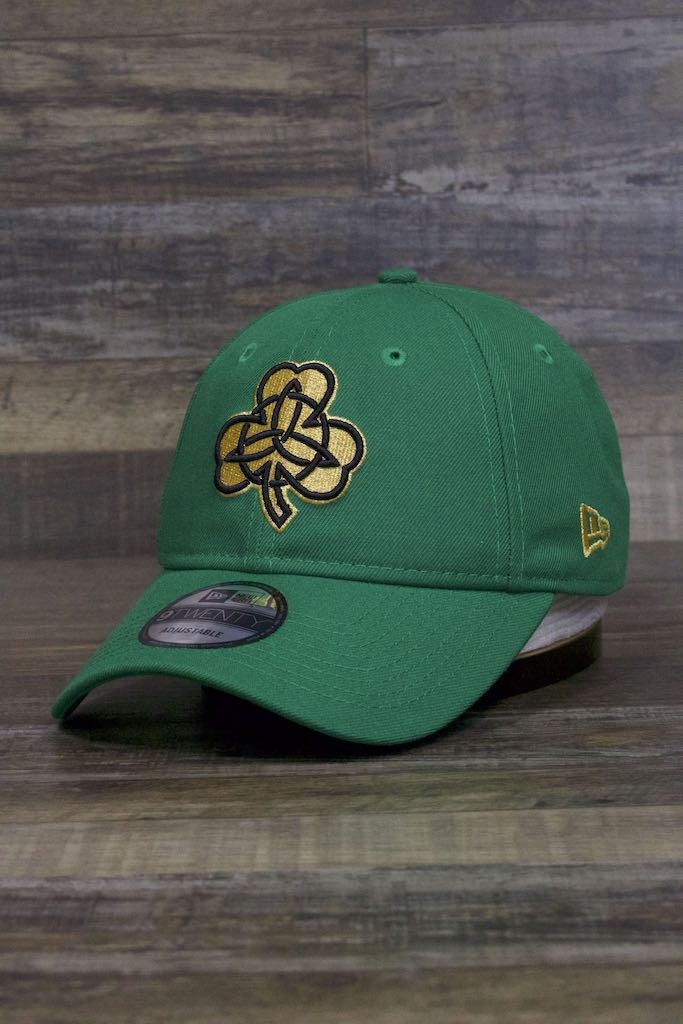 the Boston Celtics 2019 City Series Dad Hat | Irish Green Adjustable Boston Celtics Baseball Cap with Golden Shamrock has a gold clover and a bent brim on the front