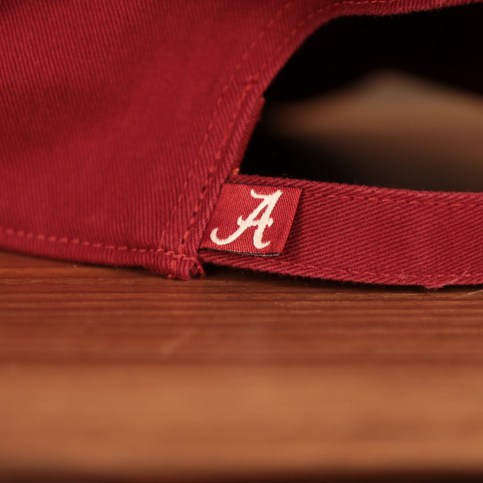 Alabama logo tag on the back of the Alabama Crimson Tide Logo Red Adjustable Dad Hat