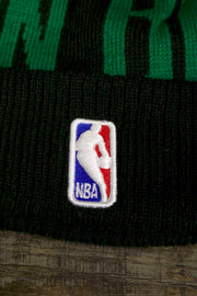 the Boston Celtics 2019 Series Tip Off Black Winter Beanie | Oversized Wordmark Celtics Beanie with Retro Leprechaun Logo has the official NBA logo on it