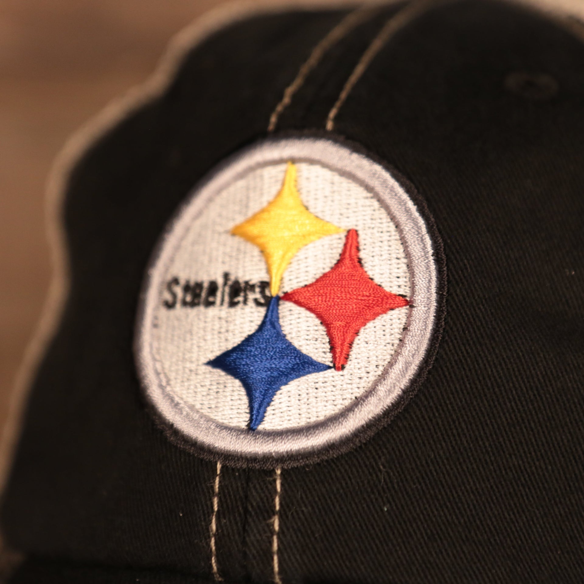 steelers logo on the Pittsburgh Steelers Black Adjustable Green Bottom Trucker Dad Hat