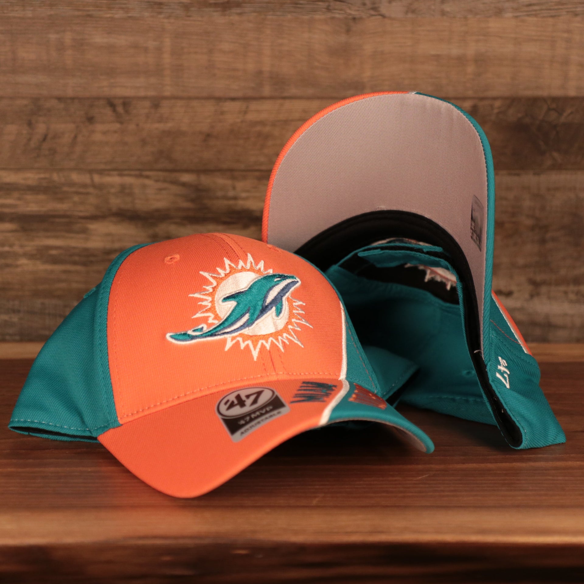 front and bottom of the Miami Dolphins Orange and Teal Adjustable Dad Hat