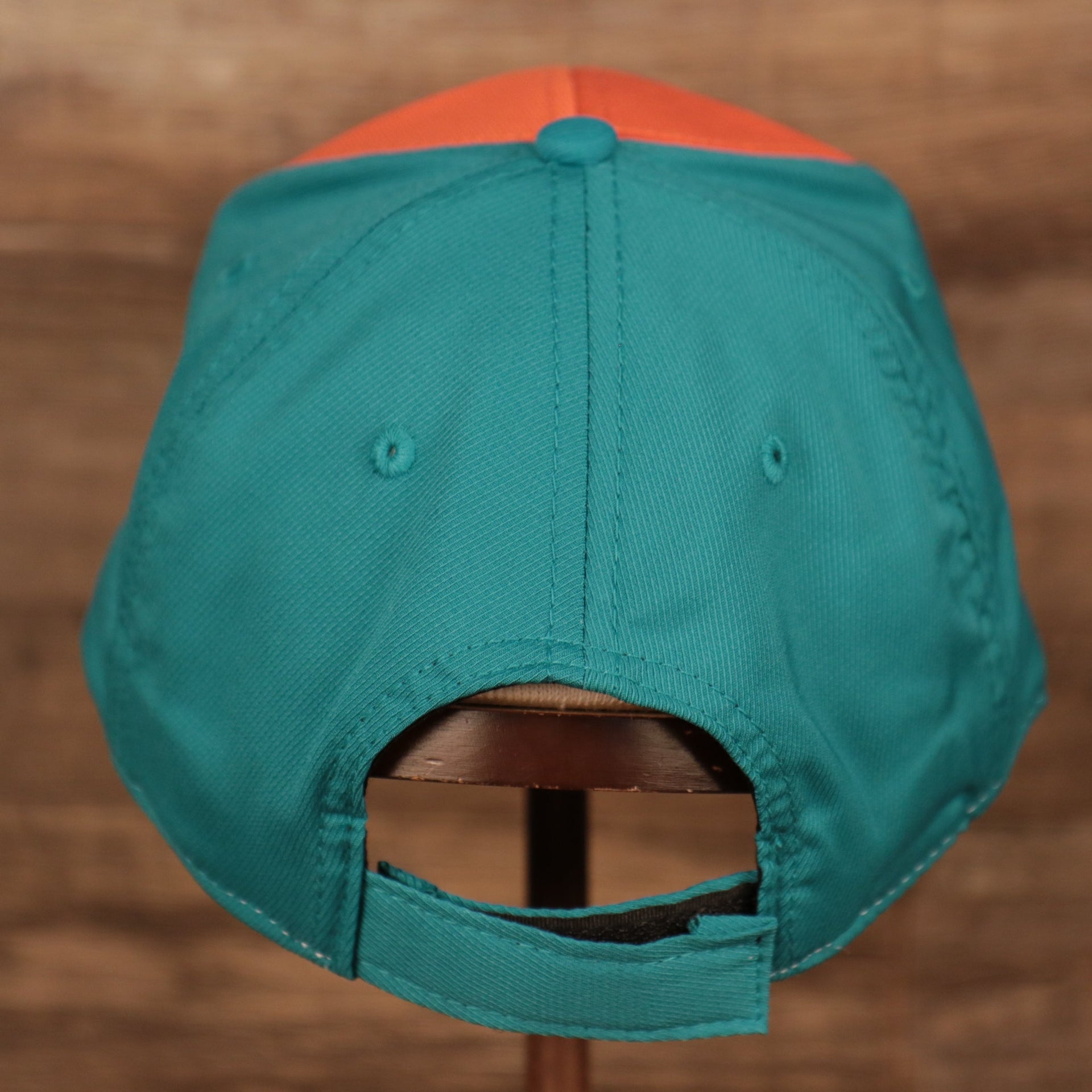 back side of the Miami Dolphins Orange and Teal Adjustable Dad Hat