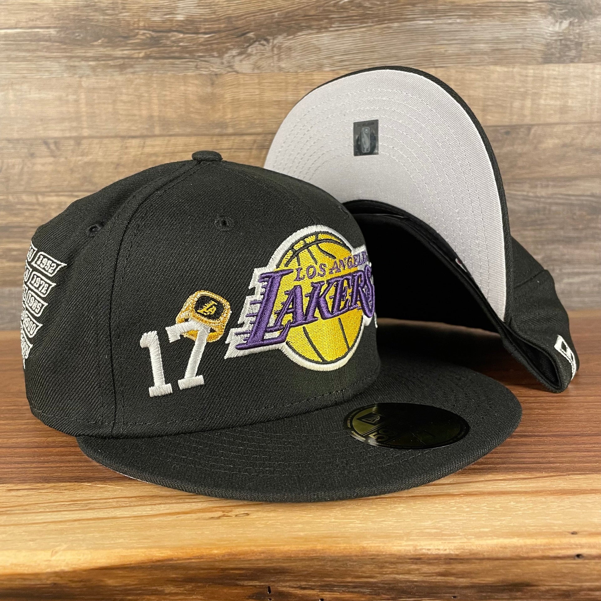 front and bottom of the Los Angeles Lakers "Championship Rings" All Over Side Patch Gray Bottom 59FIFTY Fitted Cap