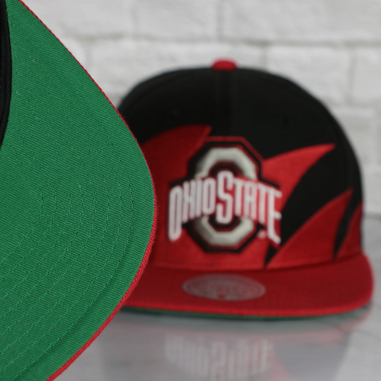 green under visor on the Ohio State University Buckeyes Vintage Retro Sharktooth Mitchell and Ness Snapback Hat | Red/Black