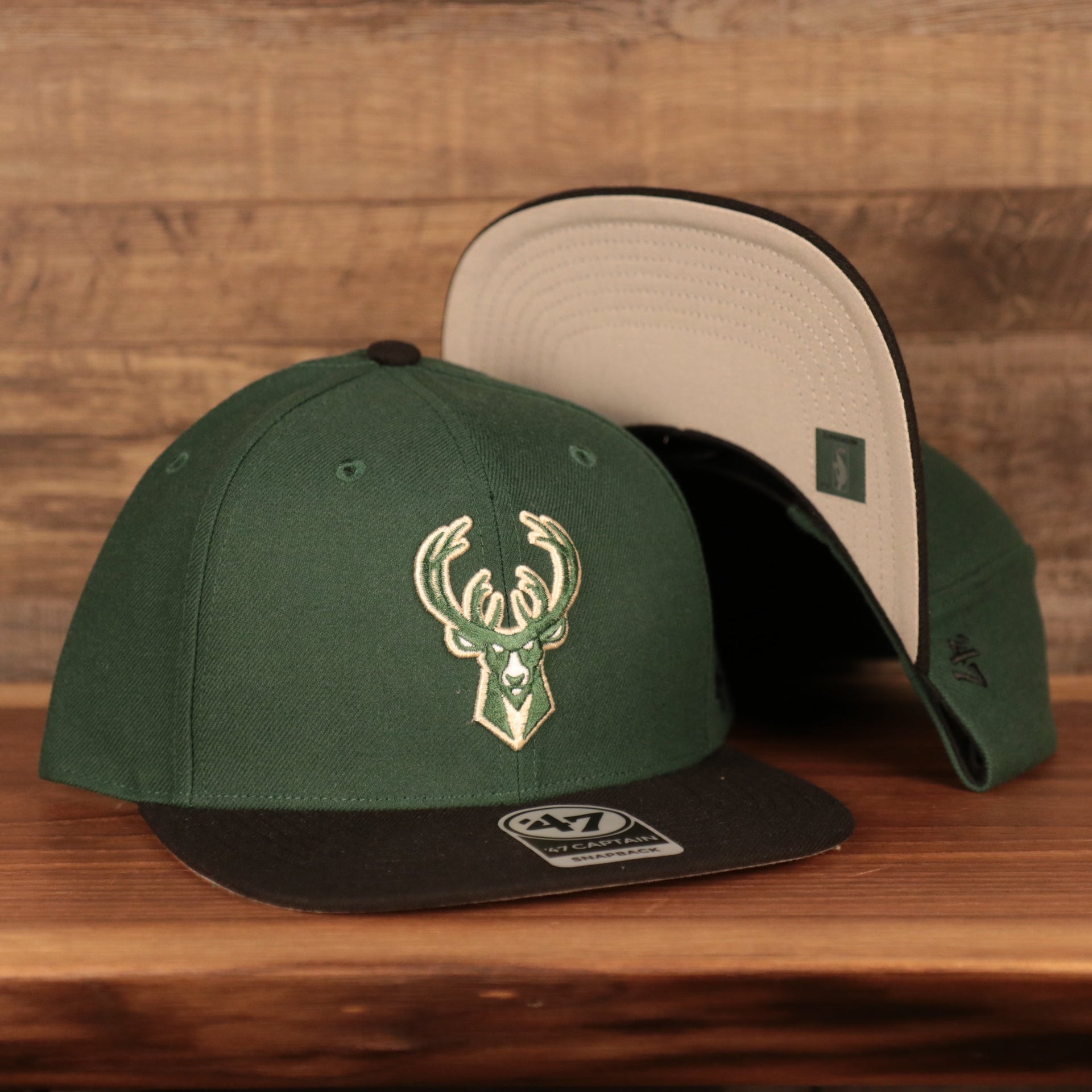 front and bottom of the Milwaukee Bucks Dark Green and Black Adjustable Grey Bottom Snapback Hat