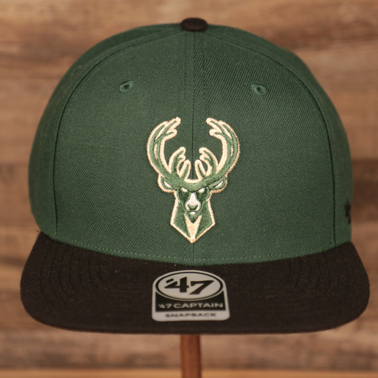 front of the Milwaukee Bucks Dark Green and Black Adjustable Grey Bottom Snapback Hat
