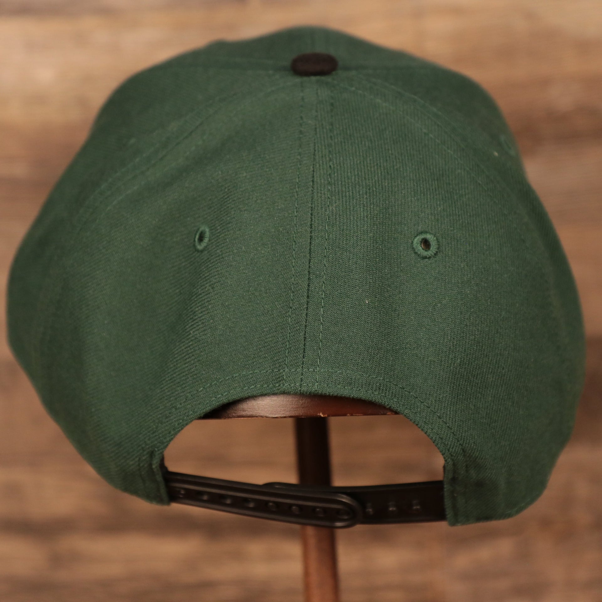 back side of the Milwaukee Bucks Dark Green and Black Adjustable Grey Bottom Snapback Hat