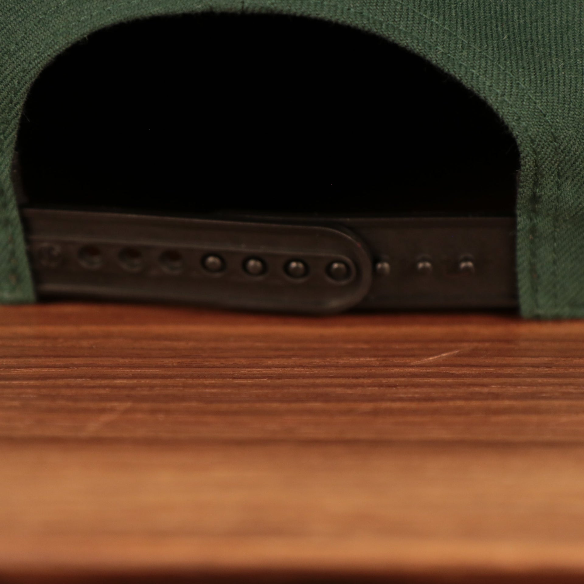 adjustable snap on the Milwaukee Bucks Dark Green and Black Adjustable Grey Bottom Snapback Hat