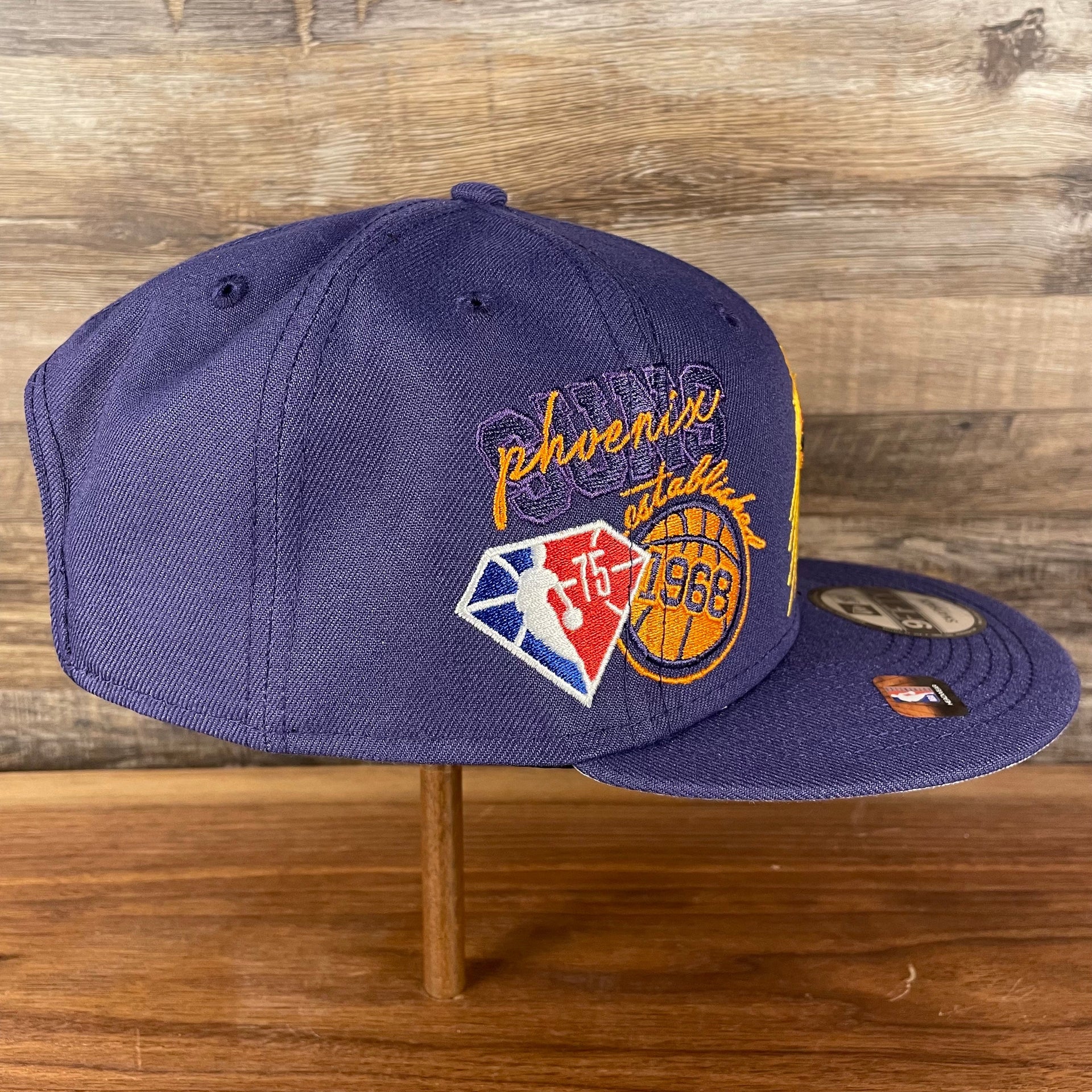 Wearer's right of the Phoenix Suns NBA 75th Anniversary Side Patch Gray Bottom Purple 9Fifty Snapback Hat | Back Half