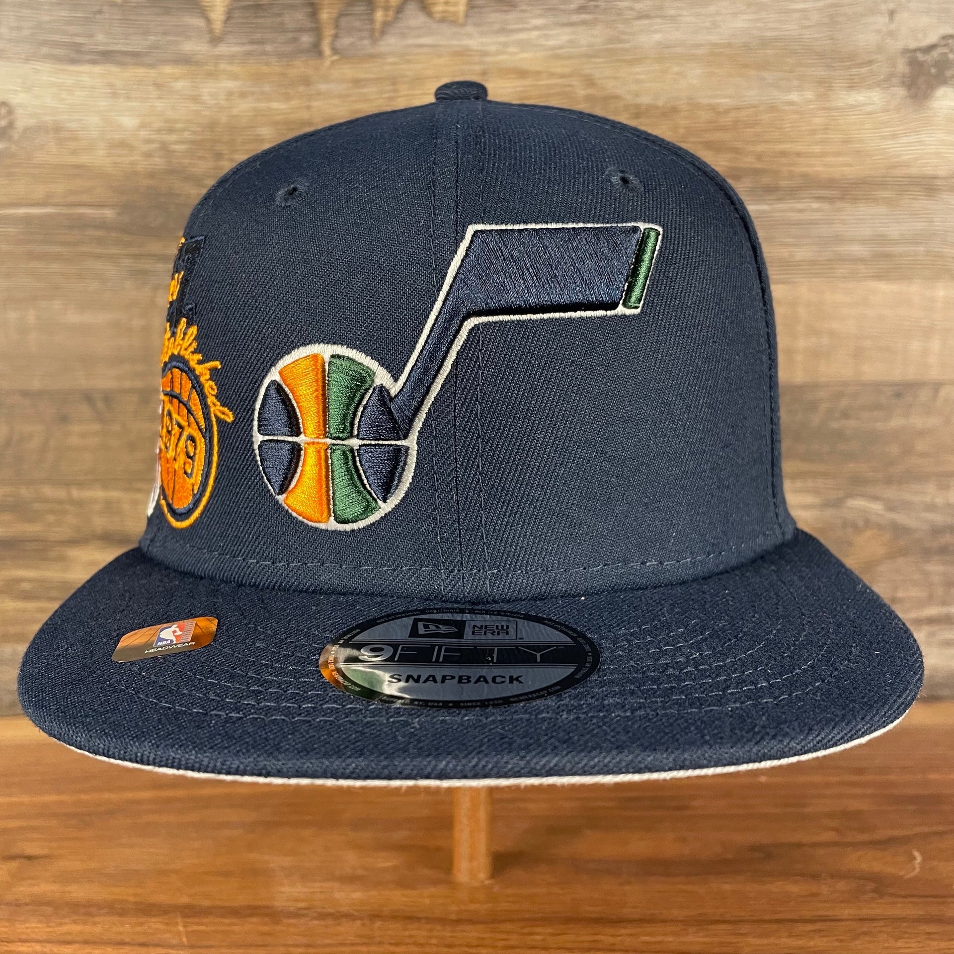Front of the Utah Jazz NBA 75th Anniversary Side Patch Gray Bottom Navy 9Fifty Snapback Hat | Back Half