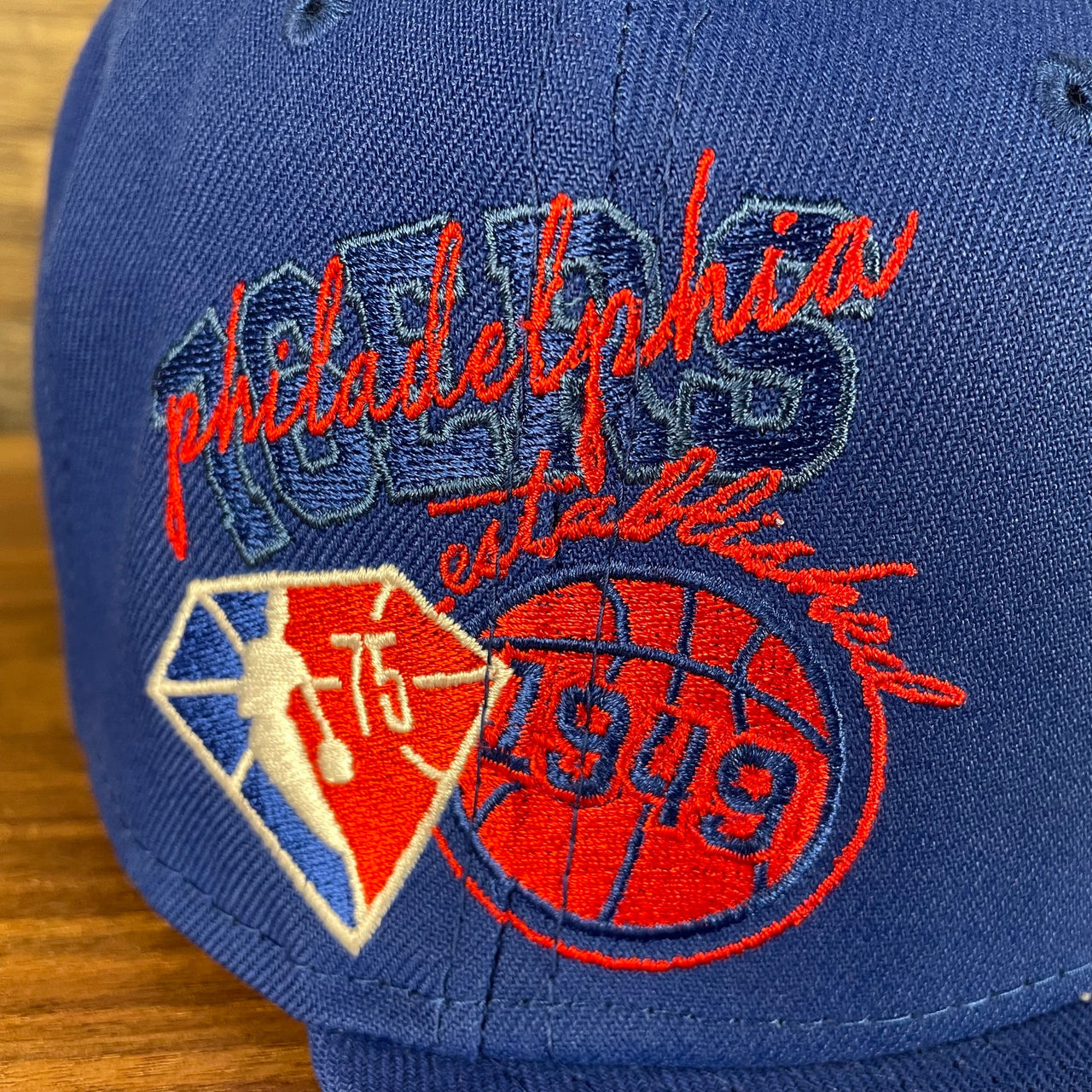 Close up of the side patch on the Philadelphia 76ers NBA 75th Anniversary Side Patch Gray Bottom Royal 9Fifty Snapback Hat | Back Half