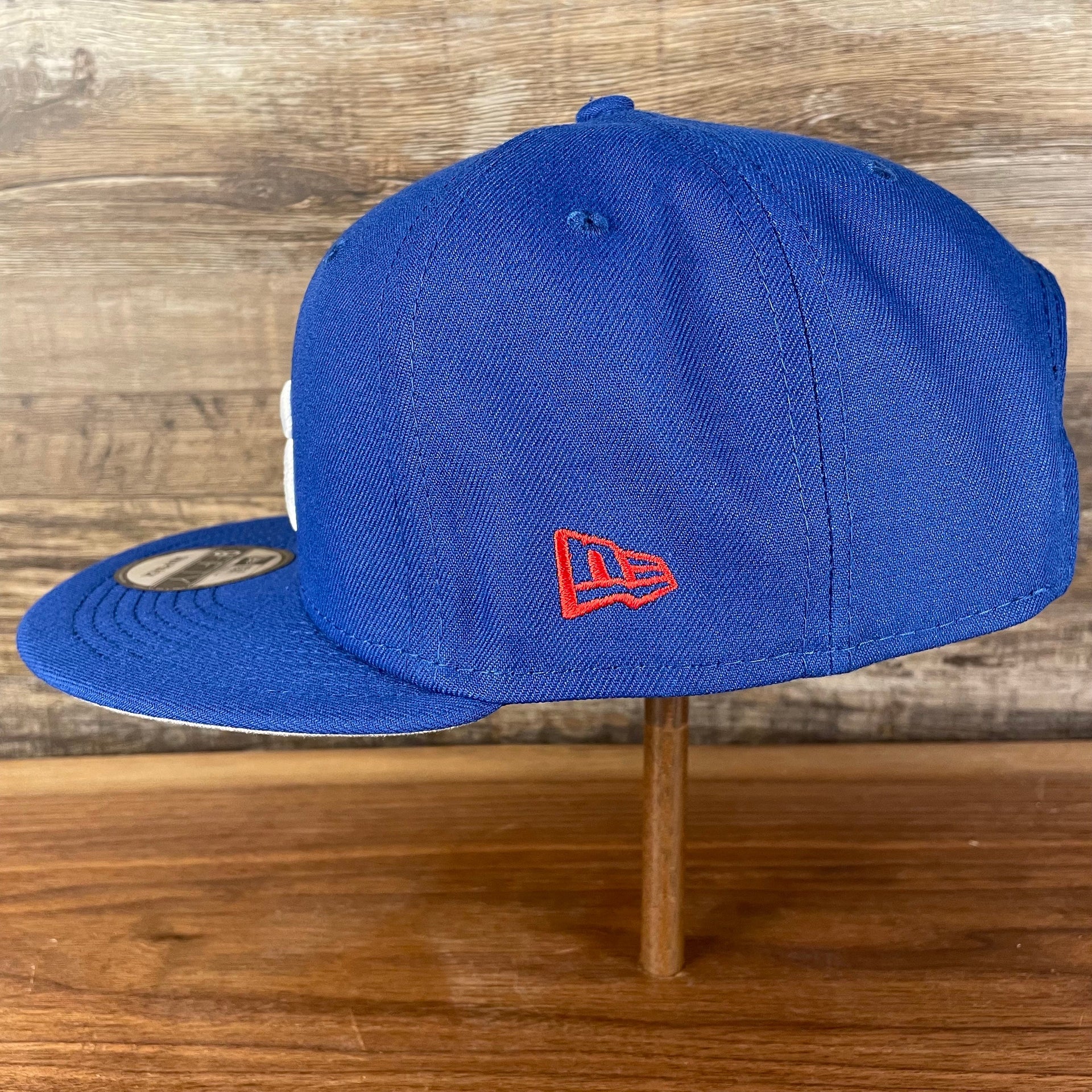 Wearer's left of the Philadelphia 76ers NBA 75th Anniversary Side Patch Gray Bottom Royal 9Fifty Snapback Hat | Back Half