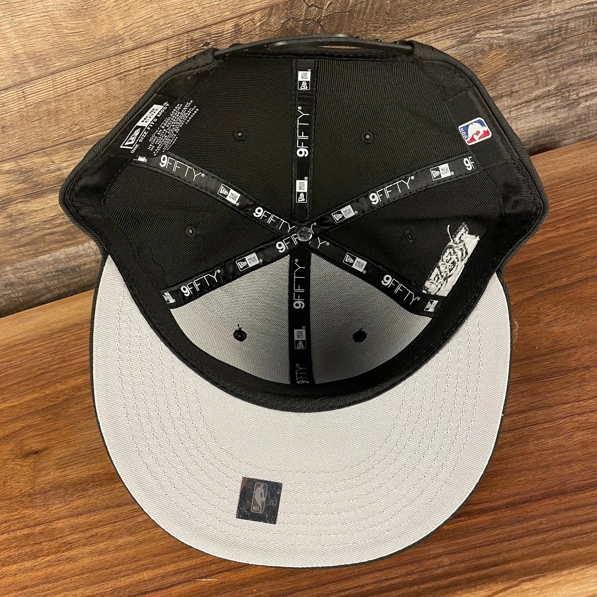 Gray under visor of the Philadelphia 76ers NBA 75th Anniversary Side Patch Gray Bottom Black 9Fifty Snapback Hat | Back Half
