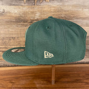 Wearer's left of the Milwaukee Bucks NBA 75th Anniversary Side Patch Gray Bottom Green 9Fifty Snapback Hat | Back Half